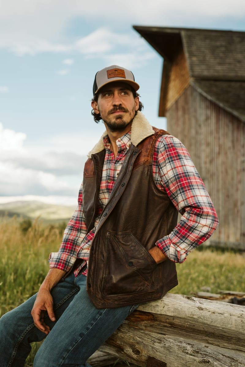 Man in brown leather jacket in landscape